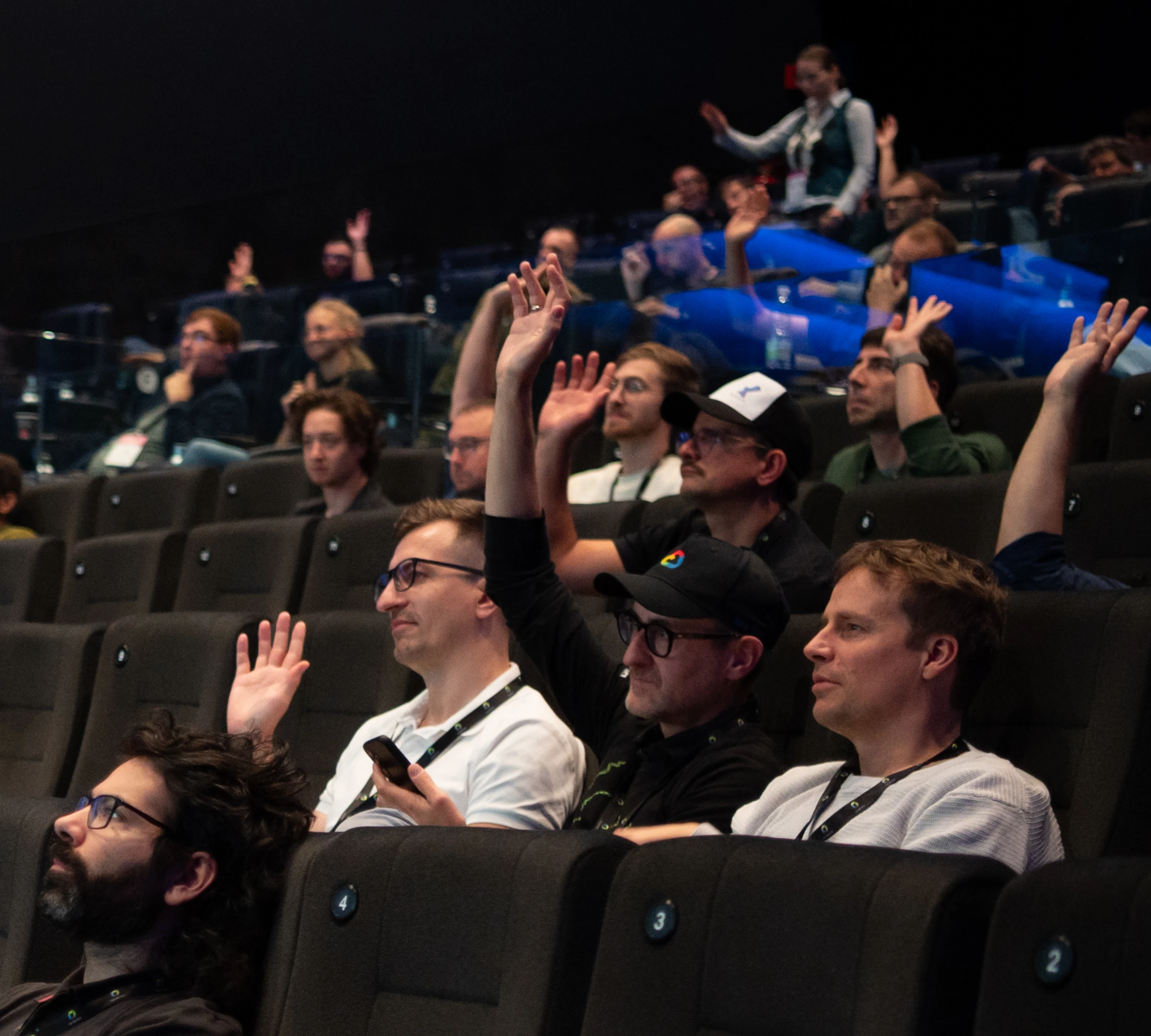 The audience of a talk answering the speaker's question by a show of hands